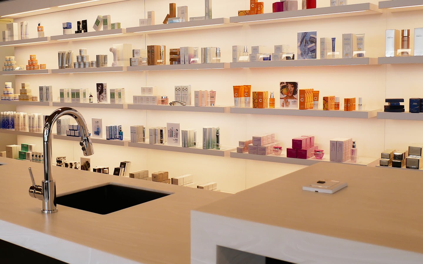 INTERIOR OF AVON STUDIO WITH SHELVES SHOWCASING A RANGE OF PRODUCTS. PHOTO: AVON