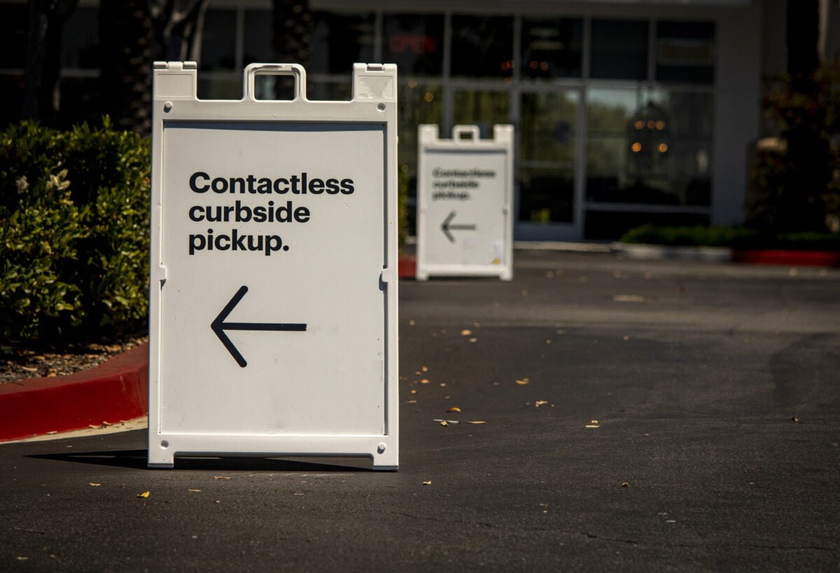 Sign advertising contactless curbside pickup at retail store parking lot